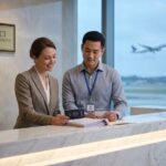 Patient and medical coordinator at international hospital reception with passport, medical records, insurance card, and JCI accreditation plaque visible
